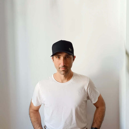 Front-facing model with the Black XL Trucker Hat for Big Heads by Free Heads.