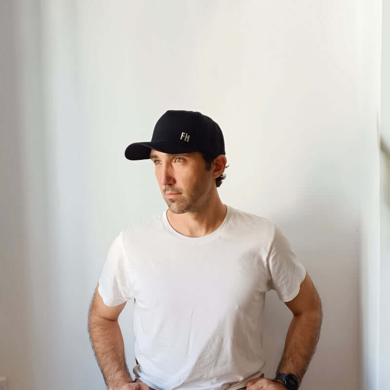 Model wearing the Black XL Trucker Hat for Big Heads by Free Heads.