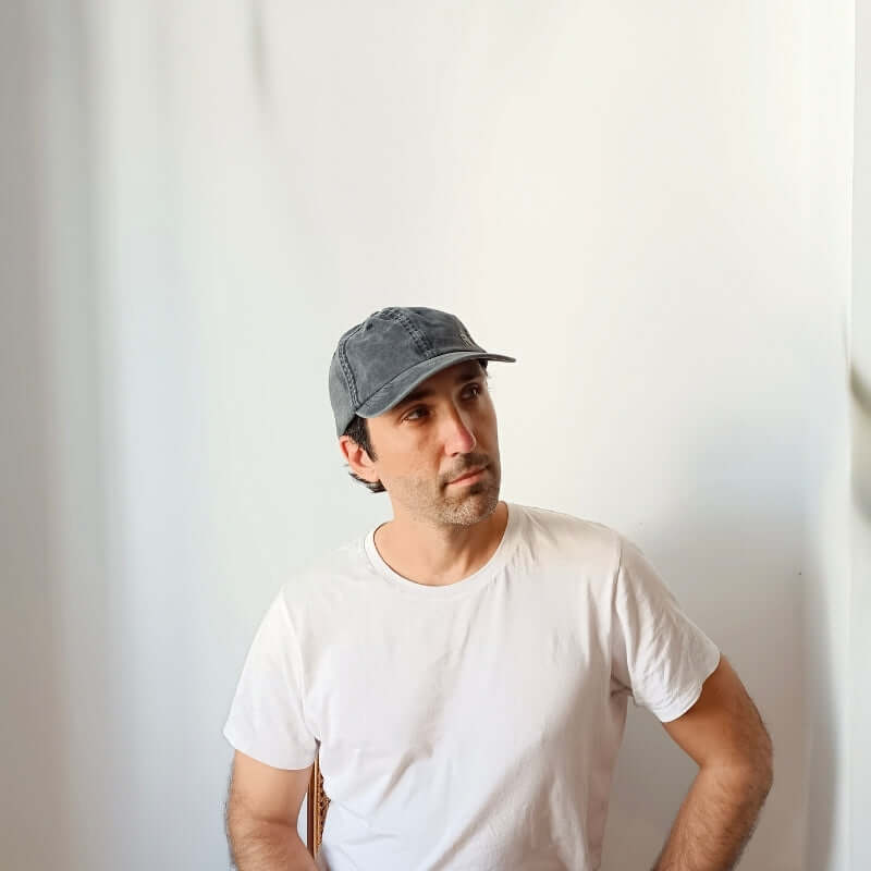 Diagonal view of model with the Black Cotton Dad Hat by Free Heads. XL Cap for Large Heads.