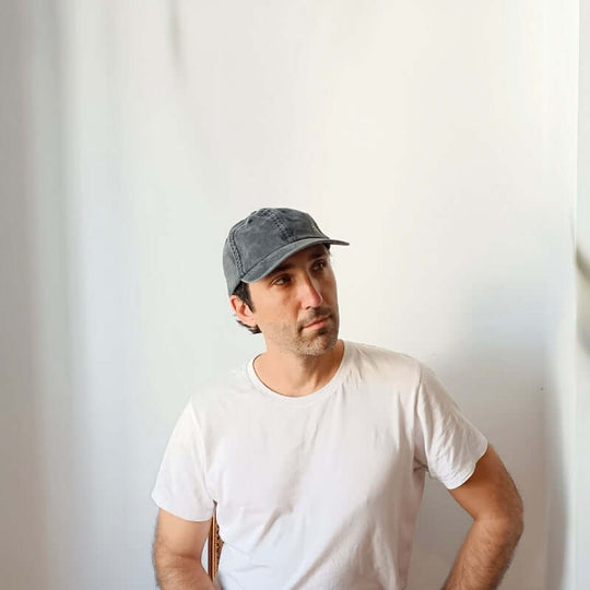 Diagonal view of model with the Black Cotton Dad Hat by Free Heads. XL Cap for Large Heads.